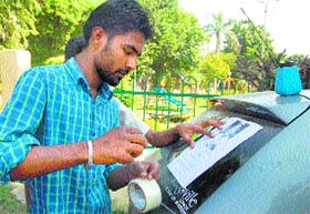 Posters of the child, who was kidnapped by certain unidentified persons on Sunday, being pasted on cars in Jalandhar on Monday