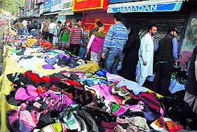 Vendors sell garments on a footpath in Srinagar.