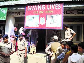 An elderly man being assisted by a personnel of the 115 Battalion of the CRPF, Zakura, during a medical camp in Ganderbal district on Monday. 