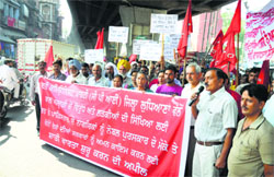 CPI activists take out a march in Ludhiana on Monday. Tribune photo: Himanshu Mahajan