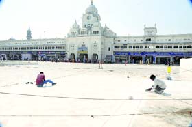 Workers give finishing touches to the Golden Temple entrance plaza in Amritsar on Monday