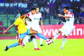 Players in action during an ISL match between North East United FC (white) and Kerela Blasters in Guwahati on Monday