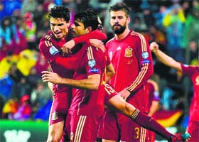 Spains Diego Costa (2L) celebrates with teammates after scoring during the Group C Euro 2016 qualifying match between Luxembourg and Spain at the Josy Barthel stadium