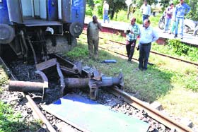 The broken parts of a coach that fell on the railway track following a snag at Jwalapur in Haridwar on Monday