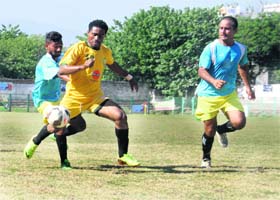 A player of Garhwal Heroes (in yellow) being tackled by players of Dehradun Football Association in the All India Narendra Kharola Memorial Football Tournament at the Pavilion Ground in Dehradun on Monday
