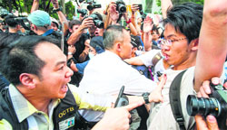 A policeman (L) warns a pro-democracy protester in the Admiralty district of Hong Kong on Monday. AFP