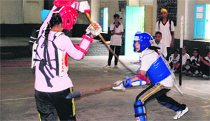 Players in action during a silambam match at school games in Amritsar on Tuesday.