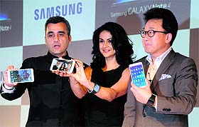 Bollywood actress Gul Panag with Asim Varsi, VP, Mobile & IT, Samsung India and SK Kim (R), MD, Sales, Samsung India, at the launch of Galaxy Note 4, priced at Rs 58,300, and Gear S phones in New Delhi on Tuesday. 
