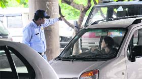 A security guard regulates vehicular movement at the Government Medical College and Hospital, Sector 32, in Chandigarh.