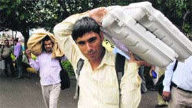 Officials take EVMs to a polling booth at Bell Colony in Panchkula on Tuesday.