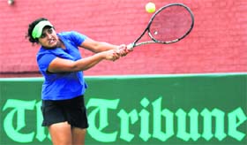 Manya Nagpal returns a shot during a tennis match of The Tribune Cup at the CLTA courts in Sector 10, Chandigarh, on Tuesday.