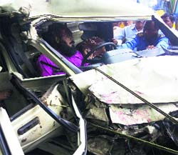 People try to rescue an accident victim from the pick-up.
