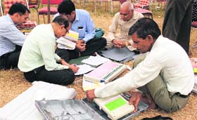 Officials check poll material at Bell Colony, Panchkula, on Tuesday.