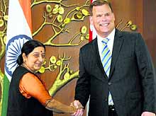 External Affairs Minister Sushma Swaraj shakes hands with her Canadian counterpart John Baird in Delhi