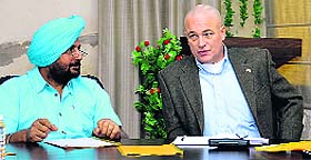 An official of the Consulate General of Canada meets an NRI Sabha official in Jalandhar on Tuesday.
