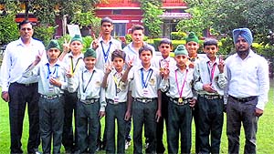 Students of Sri Guru Hargobind Public School, Thakkarwal, show their medals in Ludhiana on Tuesday. 