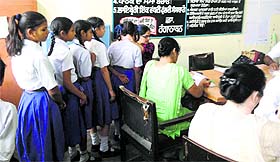 A doctor examines students during an iodine deficiency survey at a government school on Tuesday. 