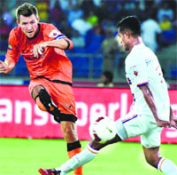 Delhi Dynamos FC captain Junker shoots at goal during their ISL match against FC Pune City in New Delhi on Tuesday. PTI