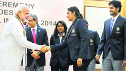 PM Narendra Modi meets Saina Mirza during the felicitation ceremony for the Asiad medallists in New Delhi on Tuesday. PTI