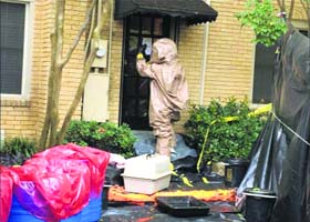 A man inspects the home of an Ebola- infected nurse in Dallas