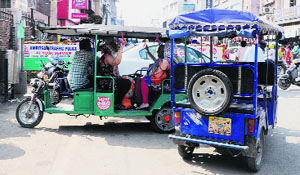 Commuters travel in a battery-operated eco-rickshaw in Amritsar.