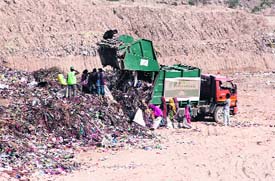garbage being dumped at the Municipal Solid Waste Treatment Plant located on Bathinda-Mansa Road
