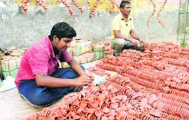 roadside vendors sell earthen lamps (diyas) on Mall Road in Bathinda on Wednesday. 