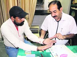 An ayurvedic doctor makes a patient aware about the importance of washing hands on Global Hand Wash Day in Bathinda. 