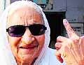 Krishna (88) is all smiles as she shows the ink mark on her finger