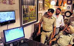 Police officials see the CCTV footage at Furniture Mart in Sector 9, Chandigarh, on Wednesday
