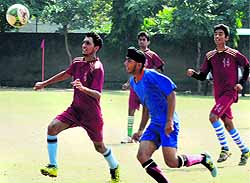 Players vie for the ball during a football match between Saint Soldier International School and Army Public School, Chandimandir, at Sector 28 in Chandigarh on Wednesday