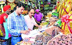 Health Department officials take samples from a shop during a raid in Sector 22, Chandigarh, on Wednesday
