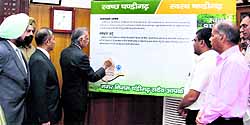 UT Administrator Shivraj Patil signs a banner to launch the signature campaign for a neat and clean city in Chandigarh