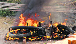 A motorcycle set afire after a clash in Barwalas Niana village on Wednesday. Photos: Bansi Lal Basniwal