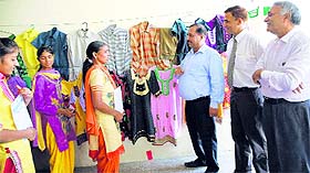 Officials inspect the garments designed by trainees at the rural self-employment training centre. 