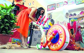 A student of the Guru Nanak Institute of Design and Technology gives the final touches to an ensemble at an exhibition in Ludhiana.