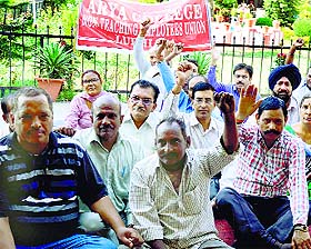 Members of the Non-Teaching Employees Union hold a protest at Arya College in Ludhiana. 