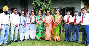 Students of BCM Arya School, who have bagged the first position in the State-Level Sanskrit Group Song Competition, strike a pose with their trophies in Ludhiana. 