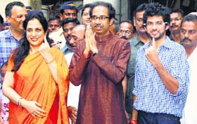 Shiv Sena chief Uddhav Thackeray accompanied by wife Rashmi and son Aditya at a poll booth in Mumbai