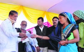 Chief Minister Harsih Rawat distributes cheques to disaster victims at Augustmuni in Dehradun on Wednesday