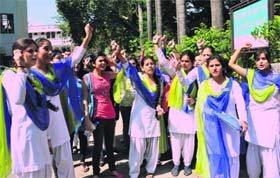 Students of MKP PG College protest at the District Magistrates office in Dehradun on Wednesday