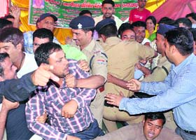 Policemen arrest members of MP Ed and BP Ed Trained Association who are unemployed and were on a hunger strike at the Parade Ground in Dehradun on Wednesday
