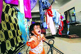A Syrian refugee child cries inside a makeshift shelter in Suruc on the Turkish-Syrian border, on Wednesday. 