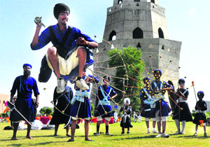 Youngsters perform "Gatka" on the birth anniversary of Baba Banda Singh Bahadur at Chappar Chiri, Mohali, on Thursday