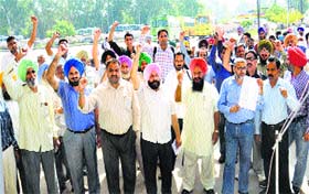 Members of the committee raise anti-government slogals during the protest at the bus terminal