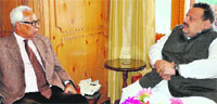 Governor NN Vohra interacts with NC provincial president and Member of Legislative Council Devender Singh Rana in Srinagar on Thursday. A Tribune photograph