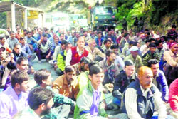 Casual employees of the GREF block the highway during a protest in Doda 