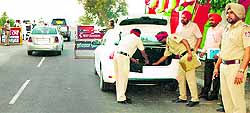 Policemen check vehicles at a round-the-clock naka set up at Kaind Bridge near Dehlon