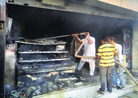 Fire fighting staff douse fire at a shop in Abohar on Thursday