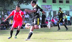 Players of Northern Railway Delhi (black) and FCI Headquarters Delhi (red) battle for take control of the ball during a match in the Narendra Kharola Memorial Football Tournament at Pavilion Ground in Dehradun on Thursday.